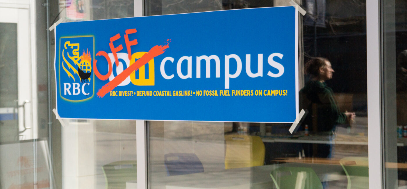 A photo of a sticker on a window. The sticker is blue and features the RBC logo with the lion holding a burning globe as well as the RBC on campus logo with the on crossed out in red and the word "off" above it.